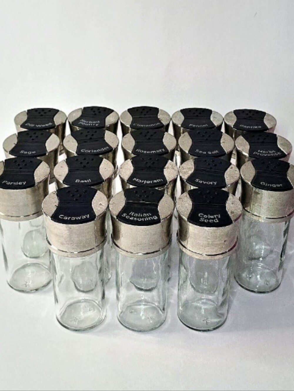 18 Piece Glass Spice Shaker Set with Silver & Black Caps.